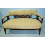 An Edwardian inlaid mahogany two-seater sofa with pierced and carved floral back, cream fabric