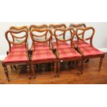 A Victorian 'Harlequin' set of eight walnut balloon back standard chairs with rouge upholstered