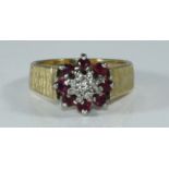 An 18ct gold, ruby and diamond ring, textured shank, illusion-set diamond surrounded by eight