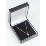 A ladies 18ct gold necklace and solitaire diamond pendant, claw-set a round brilliant cut diamond
