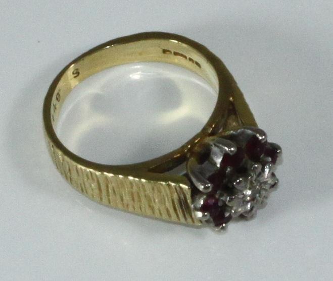 An 18ct gold, ruby and diamond ring, textured shank, illusion-set diamond surrounded by eight - Image 2 of 2