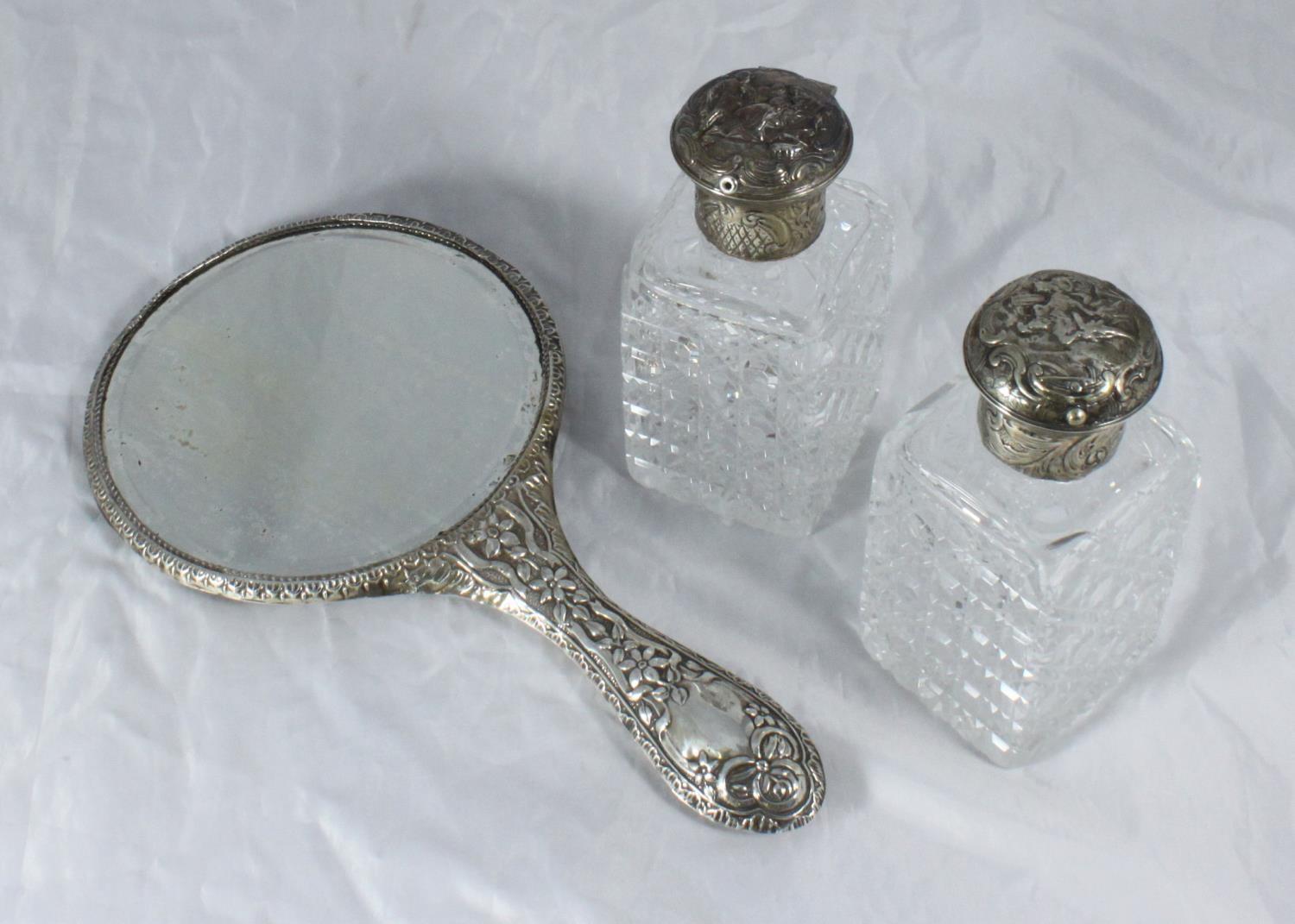 A silver-backed mirror engraved with ornate floral decoration, Chester, 1909, stamped WJM & Co,
