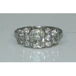 An antique Platinum & Diamond Ring, centrally six double-claw set with an oval faceted diamond