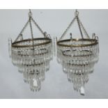 A pair of brass and cut glass four-tier lamp shades, approx. 25cm wide and 30cm from rim to base
