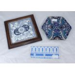 A hexagonal pottery Iznik style tile decorated with blue flowers on cream and turquoise ground,