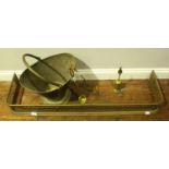 A small quantity of assorted brassware including a fender, various irons and a bucket etc.