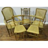 Five various stained beech wood chairs with caned backs and seats including two carvers and three
