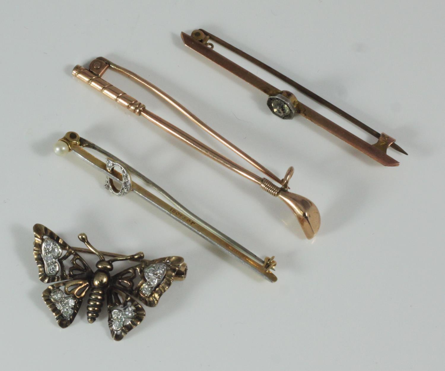 Four various brooches including gold and diamond butterfly brooch, golf club and a 15ct, platinum