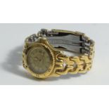 A ladies gold-plated Tag Heuer wristwatch, with ratchet bezel, gold dial, calendar aperture,