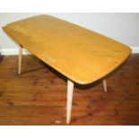 An Ercol light elm, rectangular dining table, raised on splayed, squared tapering supports, 150cm
