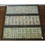 Three framed sets of 50 John Player cigarette cards including Footballers, Motorcars and