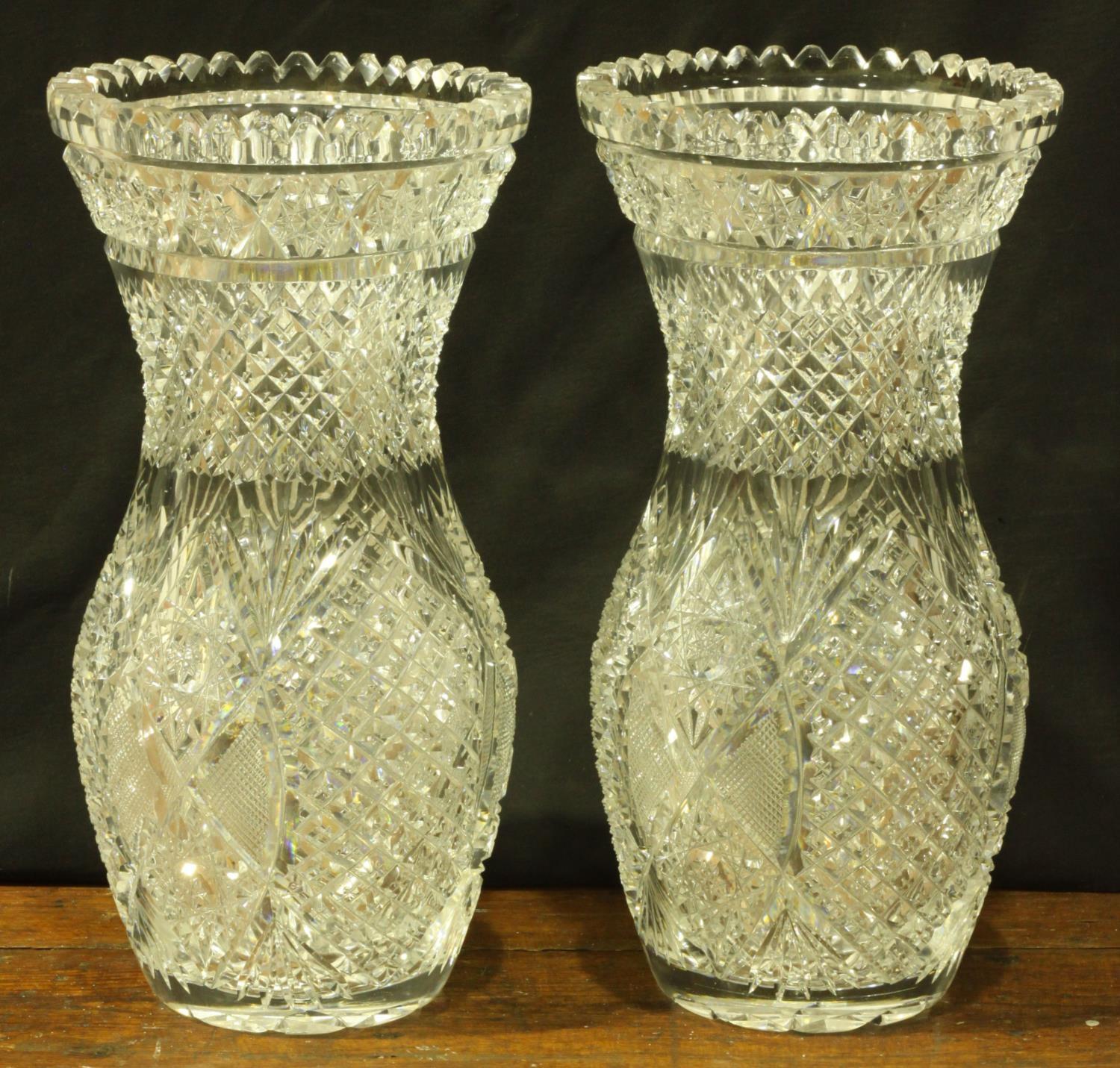 A pair of good quality, heavy, cut glass vases, possibly Waterford, of oval form with flared necks