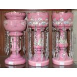 A pair of Victorian pink opaque glass lustre vases with clear prism drops, and polychrome floral