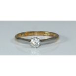 An 18ct Gold and Platinum Solitaire Diamond ring, claw set a round brilliant cut diamond estimated