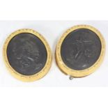 A pair of 19th century Wedgwood relief moulded black basalt oval plaques, the panels depicting '