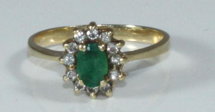 A 14K gold, emerald and diamond cluster ring, 2.77grams