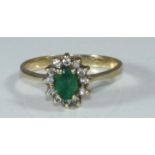 A 14K gold, emerald and diamond cluster ring, 2.77grams