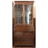 A George III stained mahogany bookcase with astragal glazed doors enclosing adjustable shelves,