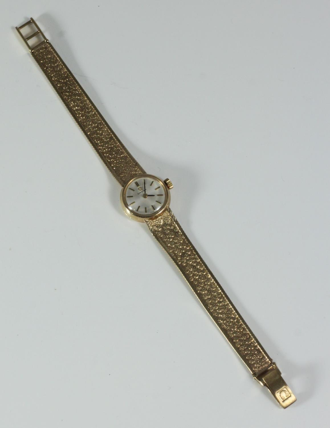 A ladies 9ct gold Omega wristwatch, with circular white dial measuring approx. 16mm not including