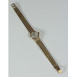 A ladies 9ct gold Omega wristwatch, with circular white dial measuring approx. 16mm not including