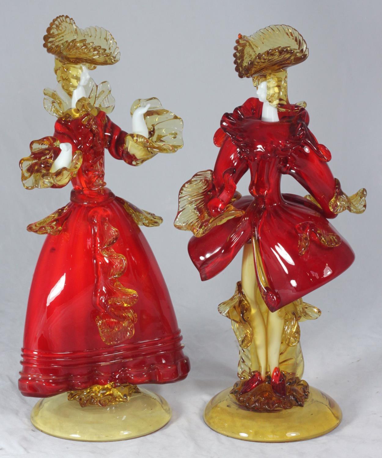 A pair of Murano glass figures of a man and a lady in 18th century style court dress, in red and