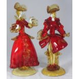 A pair of Murano glass figures of a man and a lady in 18th century style court dress, in red and