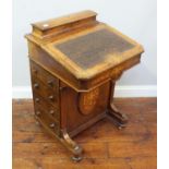 A Victorian inlaid mahogany Davenport, the raised back with lid enclosing storage space, hinged,