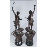 A pair of 19th century patinated spelter 'emblematic' figures, each modelled kneeling atop a lion on