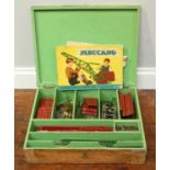 A compartmented wooden box of assorted Meccano including bolts, cogs and metal pieces, together with