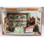 A dolls house modelled as a Christmas shop named 'Samuel Smith's' fully-furnished with counter,