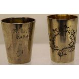 Two early twentieth century Chinese silver coloured metal tot measures, one engraved a cartouche,
