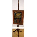 An early George II walnut pole firescreen, with a contemporary petit point needlework floral urn