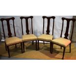 A set of four Edwardian mahogany Arts and Crafts design side chairs, the high splat backs with a