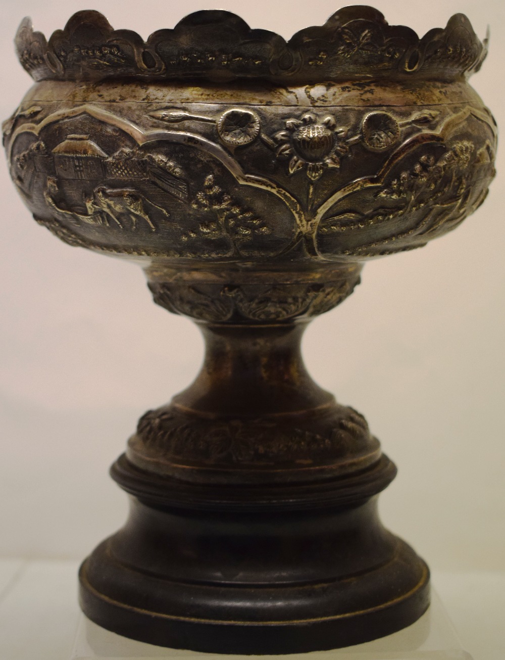 An early twentieth century Indian native silver rose bowl, with repousse domestic scenes and