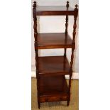 An early nineteenth century mahogany whatnot, the three tiers on turned waisted supports, with