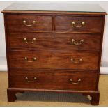 A George III mahogany chest of two short and three long graduated drawers, with brass swan neck