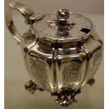 A William IV silver circular melon panelled mustard pot, with engraved hatched rococo cartouches (