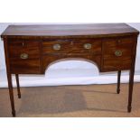 A Regency mahogany veneered bow fronted sideboard, inlaid ebony stringing, front angled corners, a