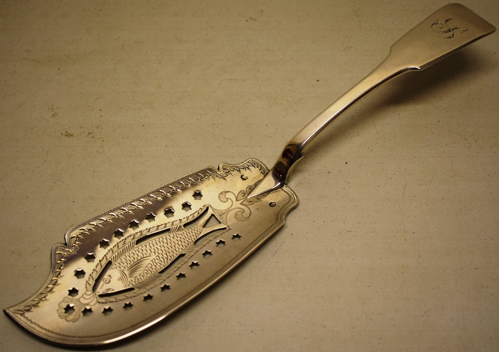 A George IV Irish silver fiddle pattern fish slice, the blade pierced and engraved with a salmon,