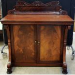 A Victorian mahogany buffet, the top with an applied carved back, with a swept front with