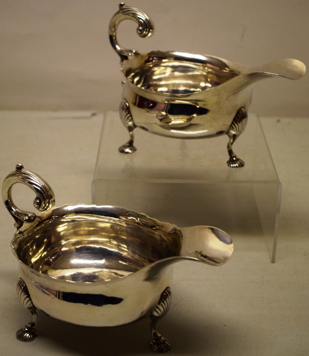 A pair of eighteenth century Irish provincial silver sauceboats, the oval bodies with a fret outline