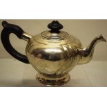 An eighteenth century Russian silver teapot, the circular body with ribbing, a cast swan neck spout,