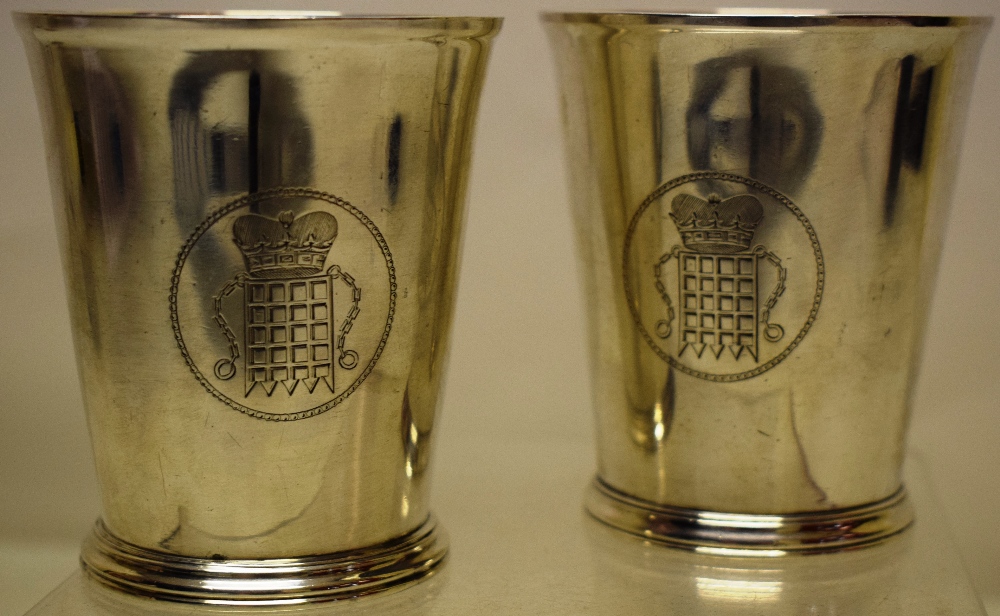 A pair of Victorian silver beakers, engraved with the arms of St Johns College Cambridge, on a