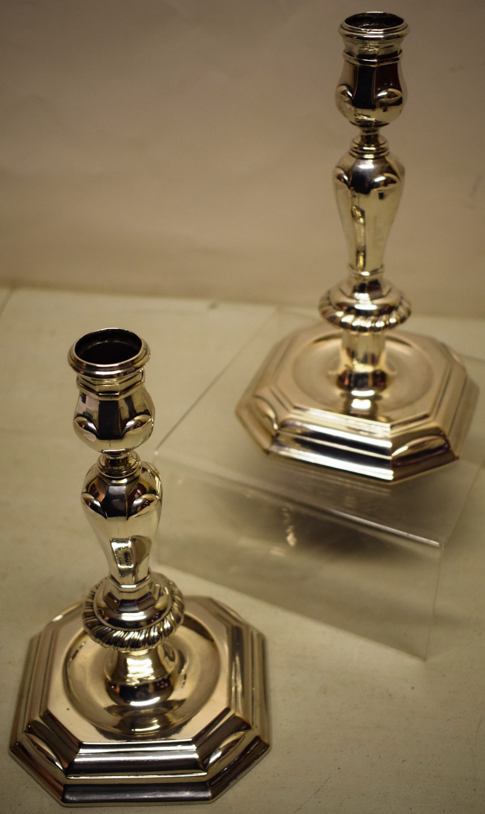 A pair of eighteenth century Swiss cast silver candlesticks, tongue moulded panelled Silesian