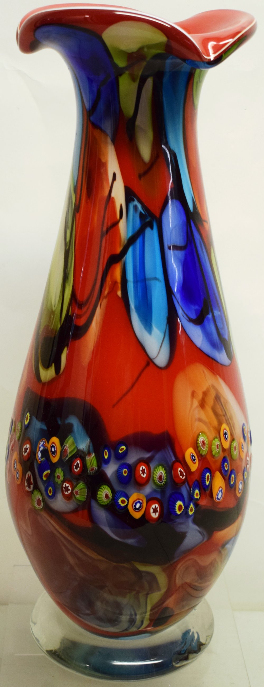 A Murano millefiore glass vase, with red and coloured marbling, a triform rim, on a circular foot,