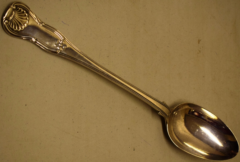 A George IV silver basting spoon, Kings hourglass pattern, engraved a lion rampant crest, 12.25in (