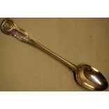 A George IV silver basting spoon, Kings hourglass pattern, engraved a lion rampant crest, 12.25in (