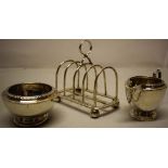 A George V silver four division toast rack, on ball feet, Maker Charles Boyton & Son, London 1910