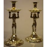 A pair of George II cast silver harlequin tapersticks, with traces of gilding, the spool shape