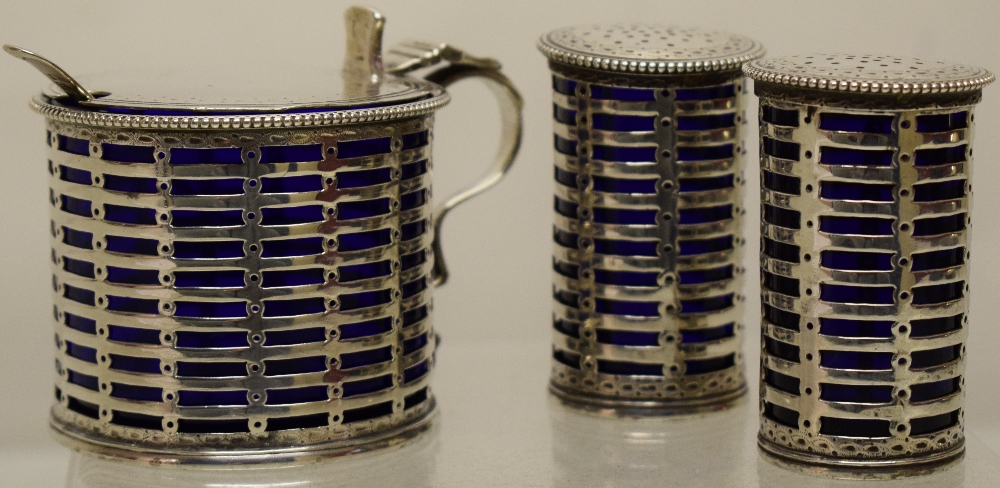 A pierced silver Georgian style pierced drum shape mustard pot, the hinged lid with a bright cut